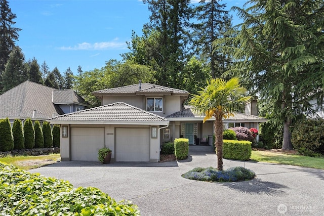 26005 225th Ct SE, Maple Valley, WA 98038 - view of front facade with an attached garage, a tile roof, driveway, and stucco siding