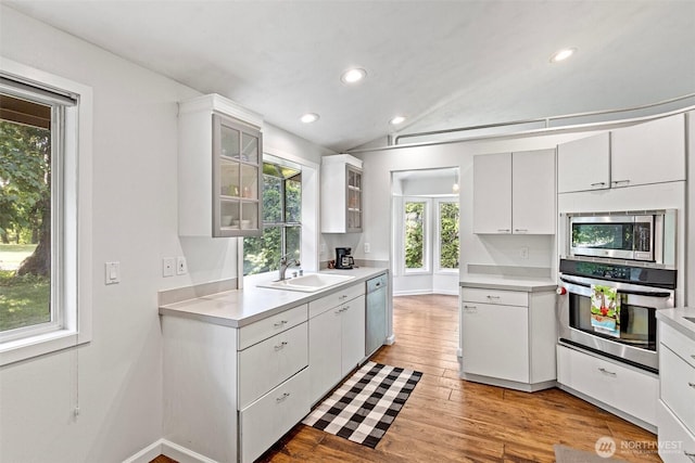 26005 225th Ct SE, Maple Valley, WA 98038 - kitchen featuring appliances with stainless steel finishes, a sink, light countertops, glass insert cabinets, and white cabinetry