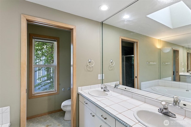 26005 225th Ct SE, Maple Valley, WA 98038 - full bath featuring a skylight, double vanity, toilet, a stall shower, and a bath