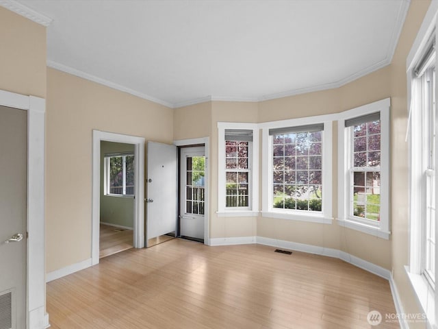 4116 25th Ave SW, Seattle, WA 98106 - unfurnished room with baseboards, light wood-style flooring, and ornamental molding