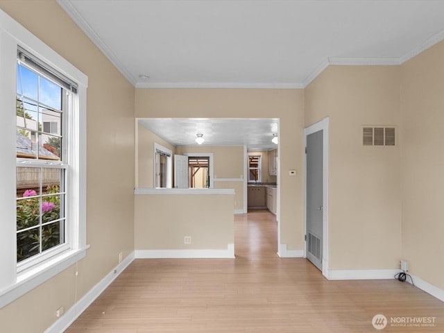 4116 25th Ave SW, Seattle, WA 98106 - unfurnished living room featuring light wood-style floors, crown molding, and baseboards