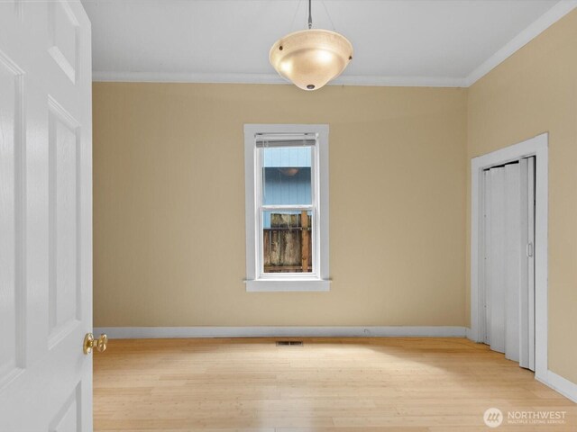 4116 25th Ave SW, Seattle, WA 98106 - unfurnished bedroom featuring wood finished floors, ornamental molding, and baseboards
