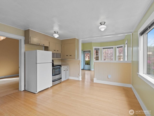 4116 25th Ave SW, Seattle, WA 98106 - kitchen featuring freestanding refrigerator, electric stove, light wood-style floors, baseboards, and light countertops