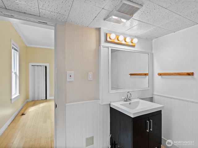 4116 25th Ave SW, Seattle, WA 98106 - bathroom with wainscoting, vanity, wood finished floors, a paneled ceiling, and wooden walls