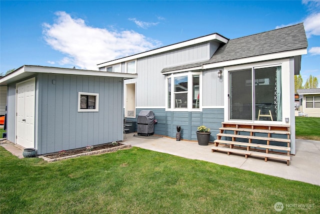 8818 Crescent Bar Rd NW Unit 46, Quincy, WA 98848 - back of property with entry steps, an outdoor structure, a yard, roof with shingles, and a patio