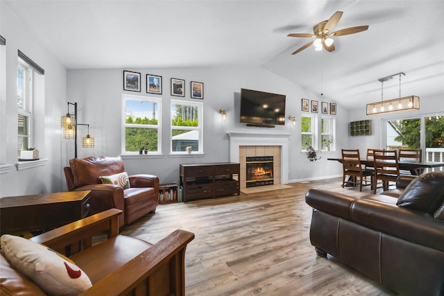 140 E Mountain View Dr, Allyn, WA 98524 - living area with a ceiling fan, vaulted ceiling, a tiled fireplace, and wood finished floors