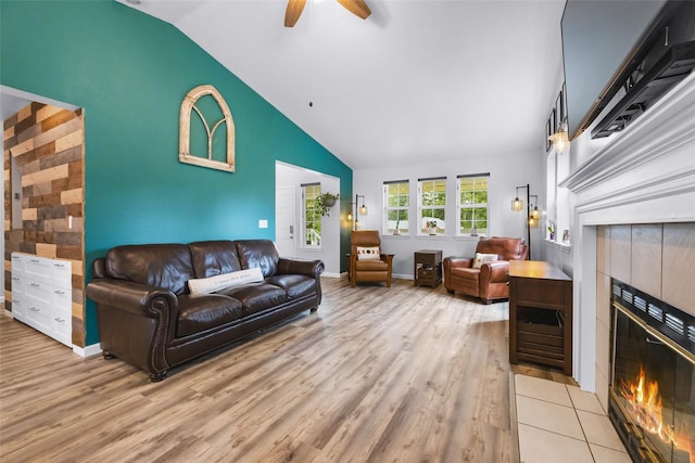 140 E Mountain View Dr, Allyn, WA 98524 - living area with a fireplace, wood finished floors, a ceiling fan, high vaulted ceiling, and baseboards