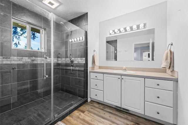 140 E Mountain View Dr, Allyn, WA 98524 - full bathroom with a shower stall, vanity, and wood finished floors