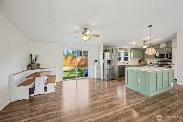 17419 11th Avenue Ct E, Spanaway, WA 98387 - kitchen featuring green cabinets, appliances with stainless steel finishes, a ceiling fan, and dark wood-type flooring