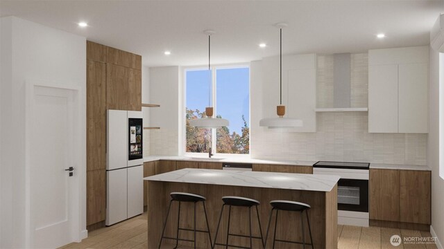 1223 N 48th St, Seattle, WA 98103 - kitchen with freestanding refrigerator, wall chimney exhaust hood, modern cabinets, a kitchen island, and a kitchen breakfast bar