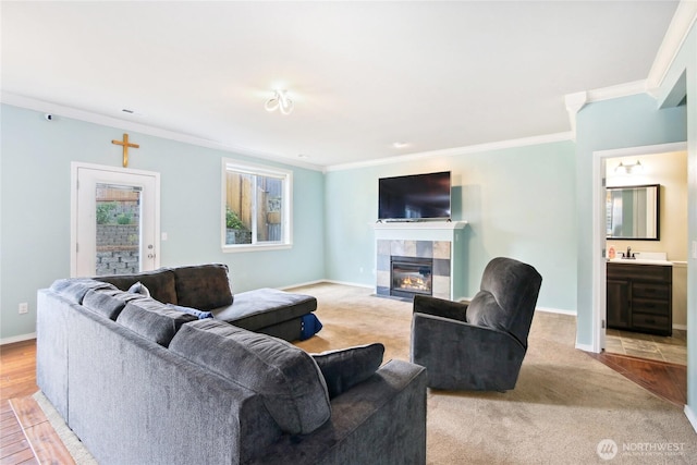 2529 10th Ct SE, Olympia, WA 98501 - living area featuring crown molding, a tiled fireplace, baseboards, and light colored carpet
