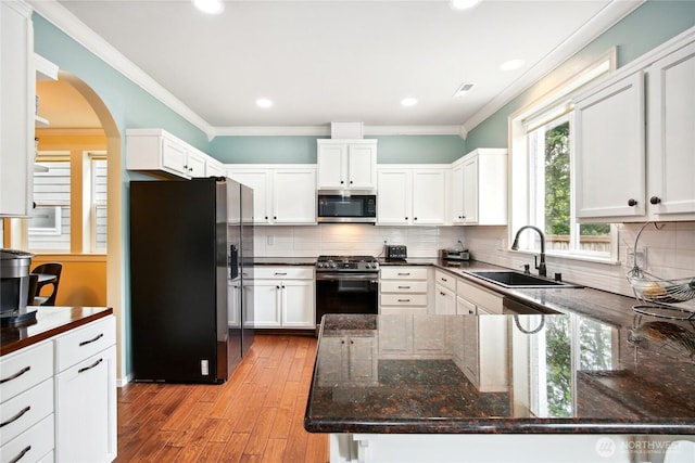 2529 10th Ct SE, Olympia, WA 98501 - kitchen with appliances with stainless steel finishes, a sink, ornamental molding, light wood finished floors, and white cabinetry