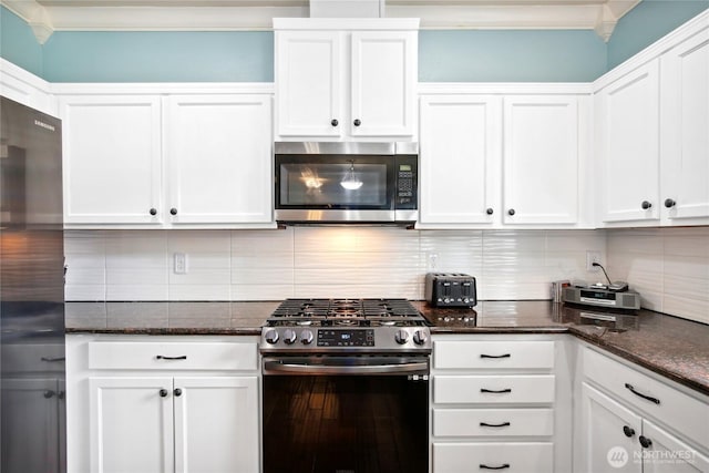 2529 10th Ct SE, Olympia, WA 98501 - kitchen with stainless steel appliances, crown molding, white cabinets, backsplash, and dark stone counters