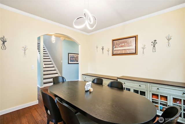 2529 10th Ct SE, Olympia, WA 98501 - dining room with arched walkways, baseboards, dark wood finished floors, stairway, and ornamental molding