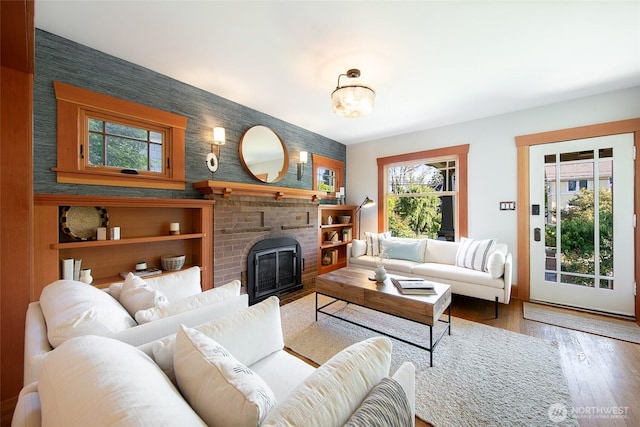528 N 83rd St, Seattle, WA 98103 - living area with an accent wall, wallpapered walls, wood finished floors, and a fireplace