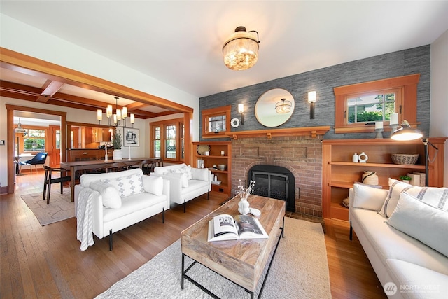 528 N 83rd St, Seattle, WA 98103 - living room with a chandelier, healthy amount of natural light, a fireplace, beam ceiling, and wood finished floors