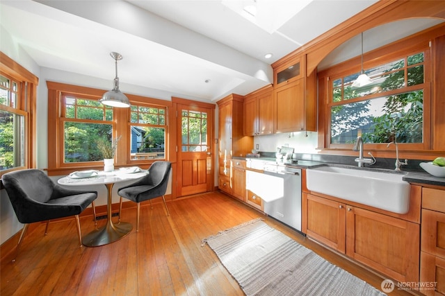 528 N 83rd St, Seattle, WA 98103 - kitchen with a sink, dishwasher, brown cabinets, and light wood-style floors