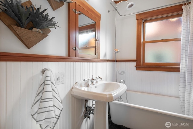 528 N 83rd St, Seattle, WA 98103 - bathroom with a freestanding tub and a wainscoted wall