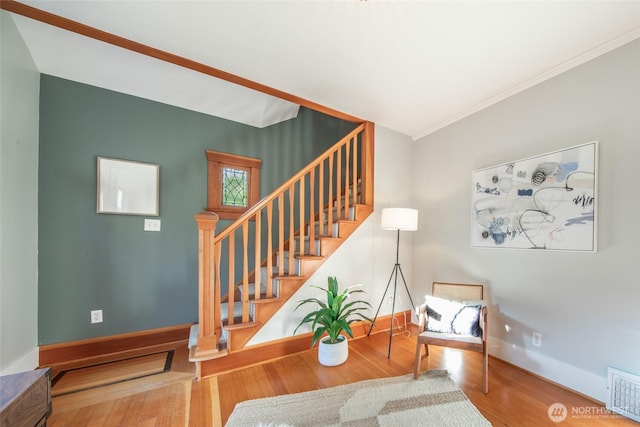 528 N 83rd St, Seattle, WA 98103 - staircase with wood finished floors, crown molding, and baseboards