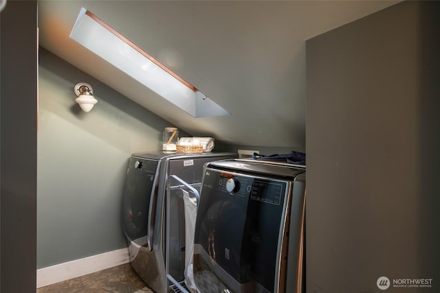 528 N 83rd St, Seattle, WA 98103 - laundry room featuring washing machine and clothes dryer, a skylight, and baseboards