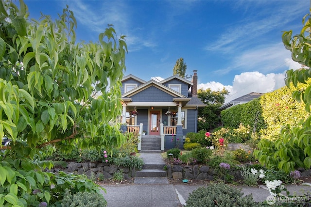 528 N 83rd St, Seattle, WA 98103 - view of front facade featuring a porch and a chimney