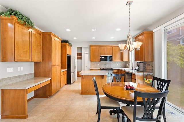 3808 Wildspitz St SE, Lacey, WA 98503 - kitchen featuring appliances with stainless steel finishes, a sink, light countertops, backsplash, and recessed lighting