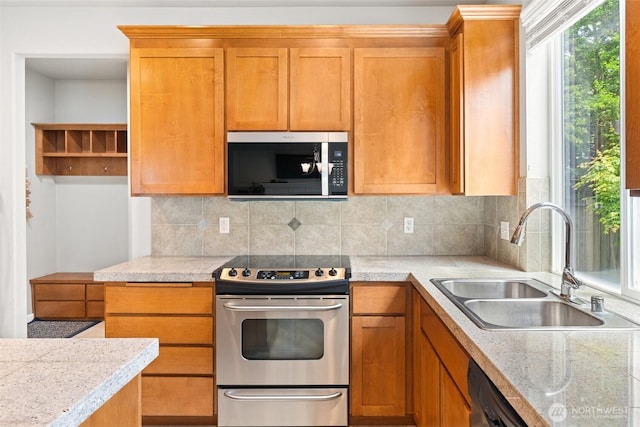3808 Wildspitz St SE, Lacey, WA 98503 - kitchen with stainless steel appliances, a sink, decorative backsplash, and brown cabinetry