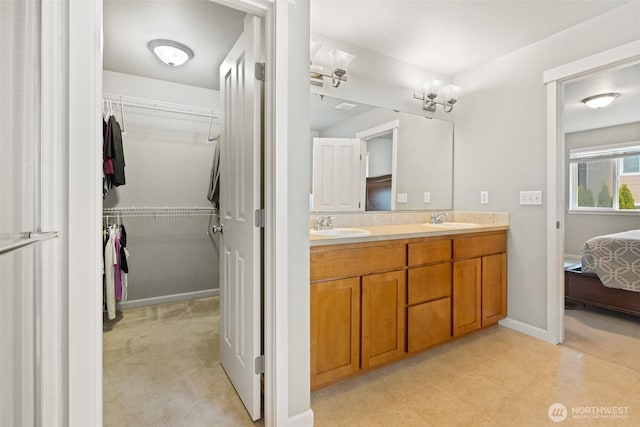 3808 Wildspitz St SE, Lacey, WA 98503 - ensuite bathroom with double vanity, a spacious closet, and baseboards