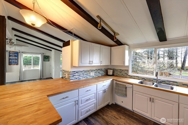 7300 V Pl, Long Beach, WA 98631 - kitchen with white dishwasher, butcher block countertops, a sink, and decorative backsplash