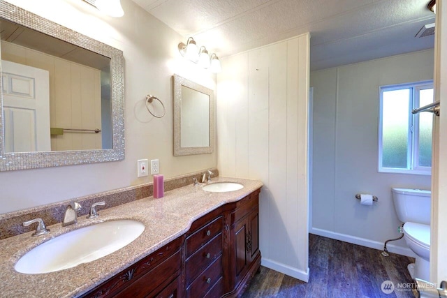 7300 V Pl, Long Beach, WA 98631 - full bath featuring wood finished floors, toilet, double vanity, and baseboards
