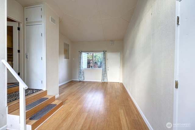 7300 V Pl, Long Beach, WA 98631 - unfurnished living room with light wood-style floors, baseboards, and stairway
