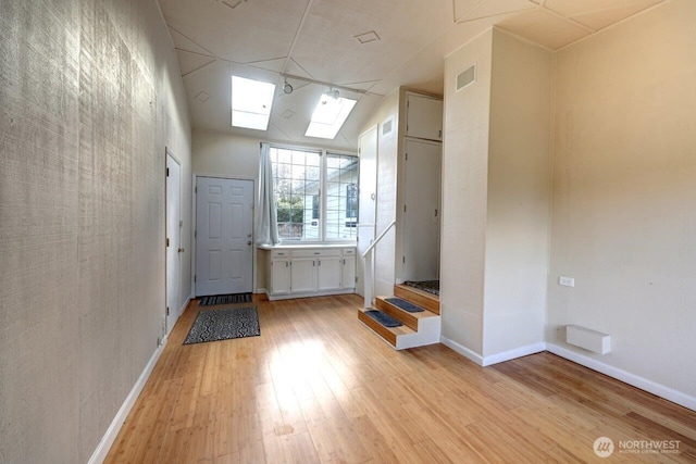 7300 V Pl, Long Beach, WA 98631 - entrance foyer with light wood finished floors, a skylight, and baseboards
