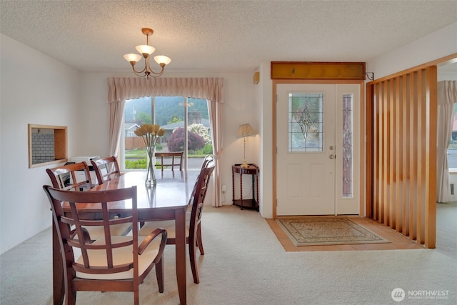 284 Division Ave, Morton, WA 98356 - dining space with carpet floors, a chandelier, and a textured ceiling