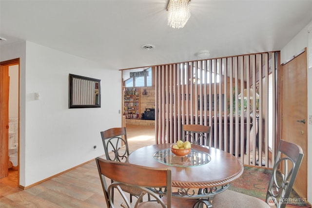 284 Division Ave, Morton, WA 98356 - dining area with light wood-style floors, a chandelier, and baseboards