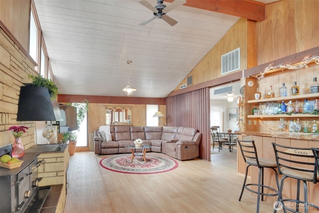 284 Division Ave, Morton, WA 98356 - living room featuring wood walls, a ceiling fan, plenty of natural light, light wood-style floors, and high vaulted ceiling