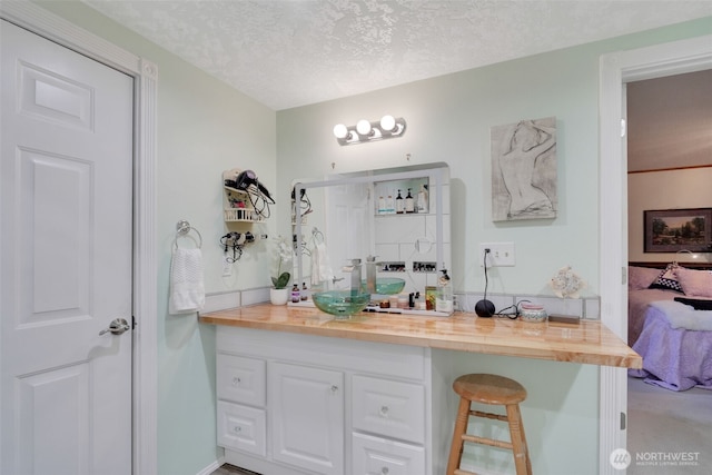 284 Division Ave, Morton, WA 98356 - ensuite bathroom featuring vanity and a textured ceiling