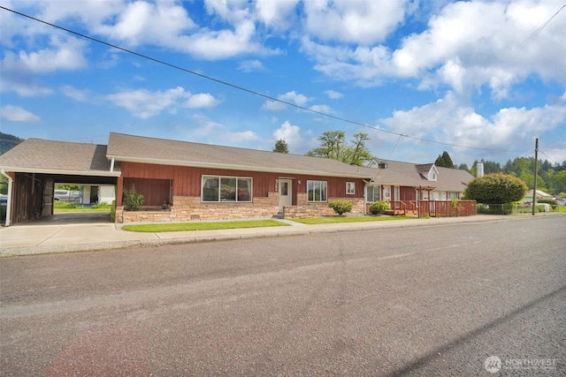 284 Division Ave, Morton, WA 98356 - ranch-style house featuring driveway, stone siding, an attached carport, roof with shingles, and board and batten siding