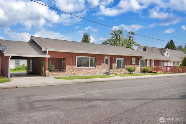 284 Division Ave, Morton, WA 98356 - ranch-style home with stone siding, roof with shingles, an attached carport, and driveway