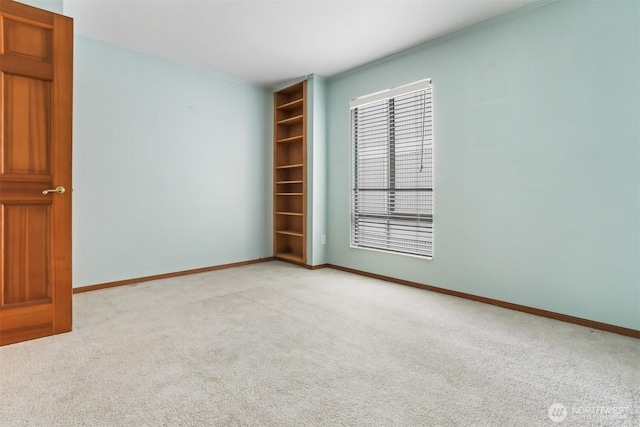 8005 Sand Point Way NE Unit A45, Seattle, WA 98115 - spare room featuring light colored carpet, baseboards, and crown molding