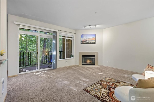 18930 Bothell Everett Hwy Unit V201, Bothell, WA 98012 - unfurnished living room featuring carpet floors, a fireplace with flush hearth, and baseboards