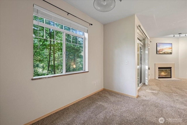 18930 Bothell Everett Hwy Unit V201, Bothell, WA 98012 - unfurnished room with carpet, a fireplace with flush hearth, and baseboards
