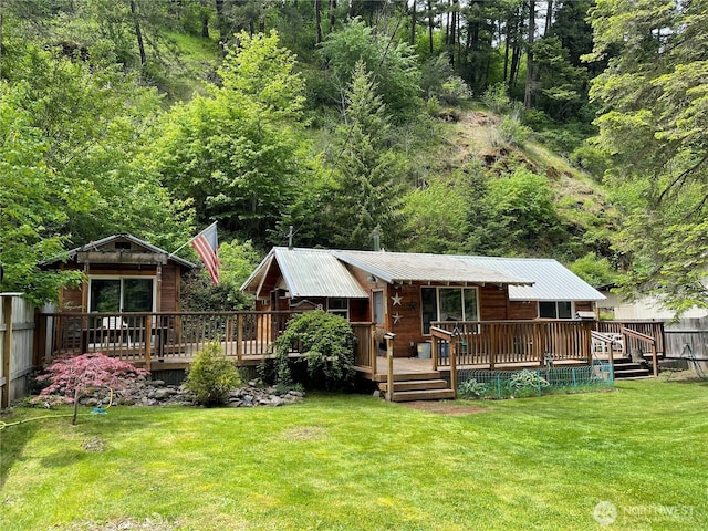 48 Blue Jay Loop, Walla Walla, WA 99362 - back of property featuring a wooden deck, metal roof, and a view of trees
