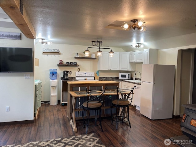 48 Blue Jay Loop, Walla Walla, WA 99362 - kitchen featuring white appliances, white cabinetry, dark wood finished floors, a textured ceiling, and a center island