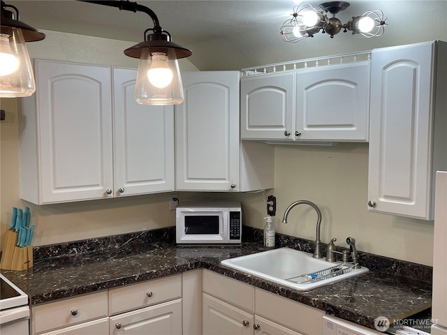 48 Blue Jay Loop, Walla Walla, WA 99362 - kitchen with white appliances, a sink, white cabinets, and dark stone counters
