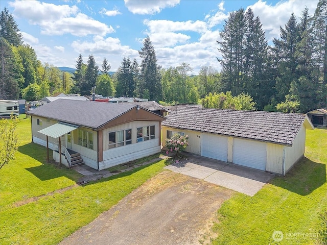 315 Washington St, Pe Ell, WA 98572 - view of front of property featuring dirt driveway, a front lawn, an attached garage, and an outdoor structure