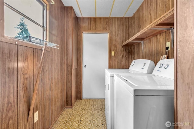 315 Washington St, Pe Ell, WA 98572 - laundry area featuring washing machine and dryer, wood walls, and light floors