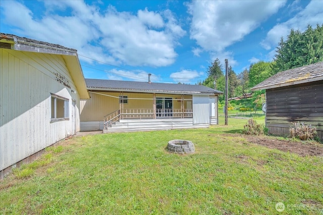 315 Washington St, Pe Ell, WA 98572 - rear view of house featuring a yard and a fire pit