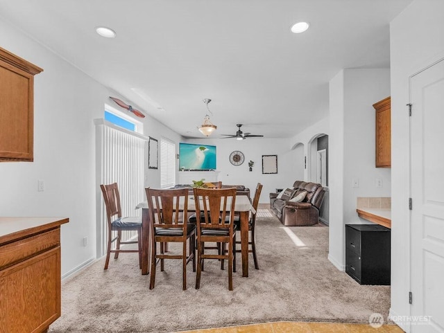 530 N Kentucky Dr, Moses Lake, WA 98837 - dining space with light carpet, a ceiling fan, arched walkways, recessed lighting, and baseboards