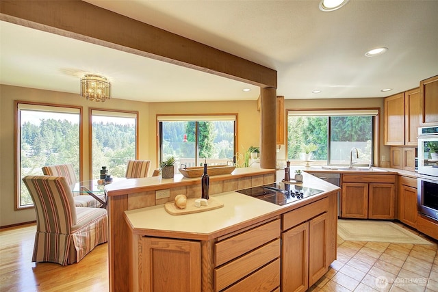 9430 Hoeder Ln, Bothell, WA 98011 - kitchen with black electric cooktop, a sink, a kitchen island, light countertops, and recessed lighting