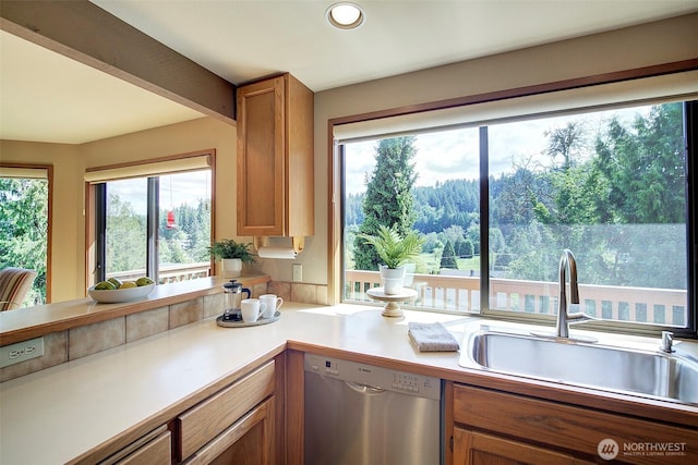 9430 Hoeder Ln, Bothell, WA 98011 - kitchen featuring dishwasher, a sink, light countertops, brown cabinets, and recessed lighting